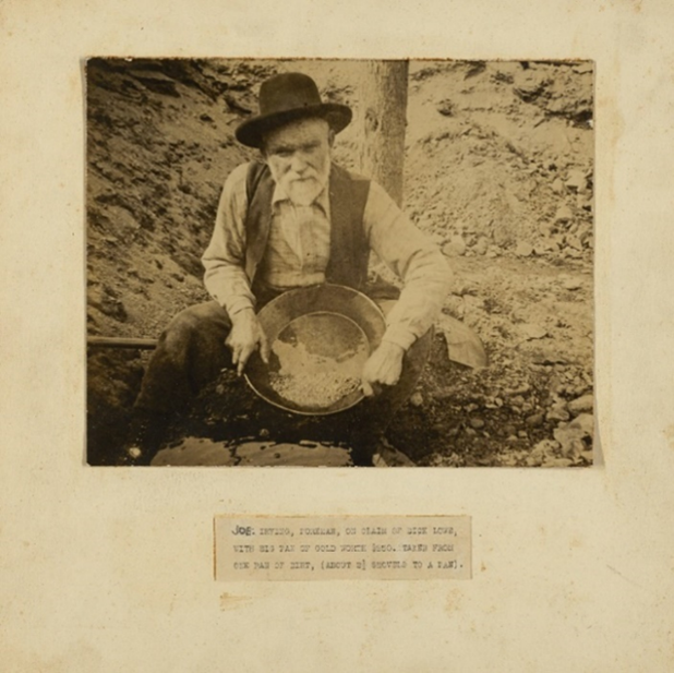 Joe Irving, Foreman, on claim of Dick Lowe, with big pan of gold worth $850. Taken from one pan of dirt, (about 2 1/2 shovels to a pan)